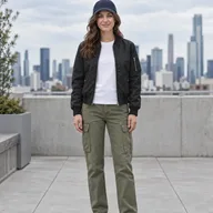 Woman on a city rooftop in a black bomber jacket, white tee and olive cargo pants